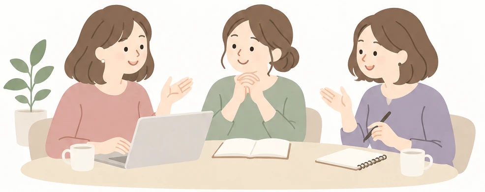 机を囲んで話す3人の女性のイラスト